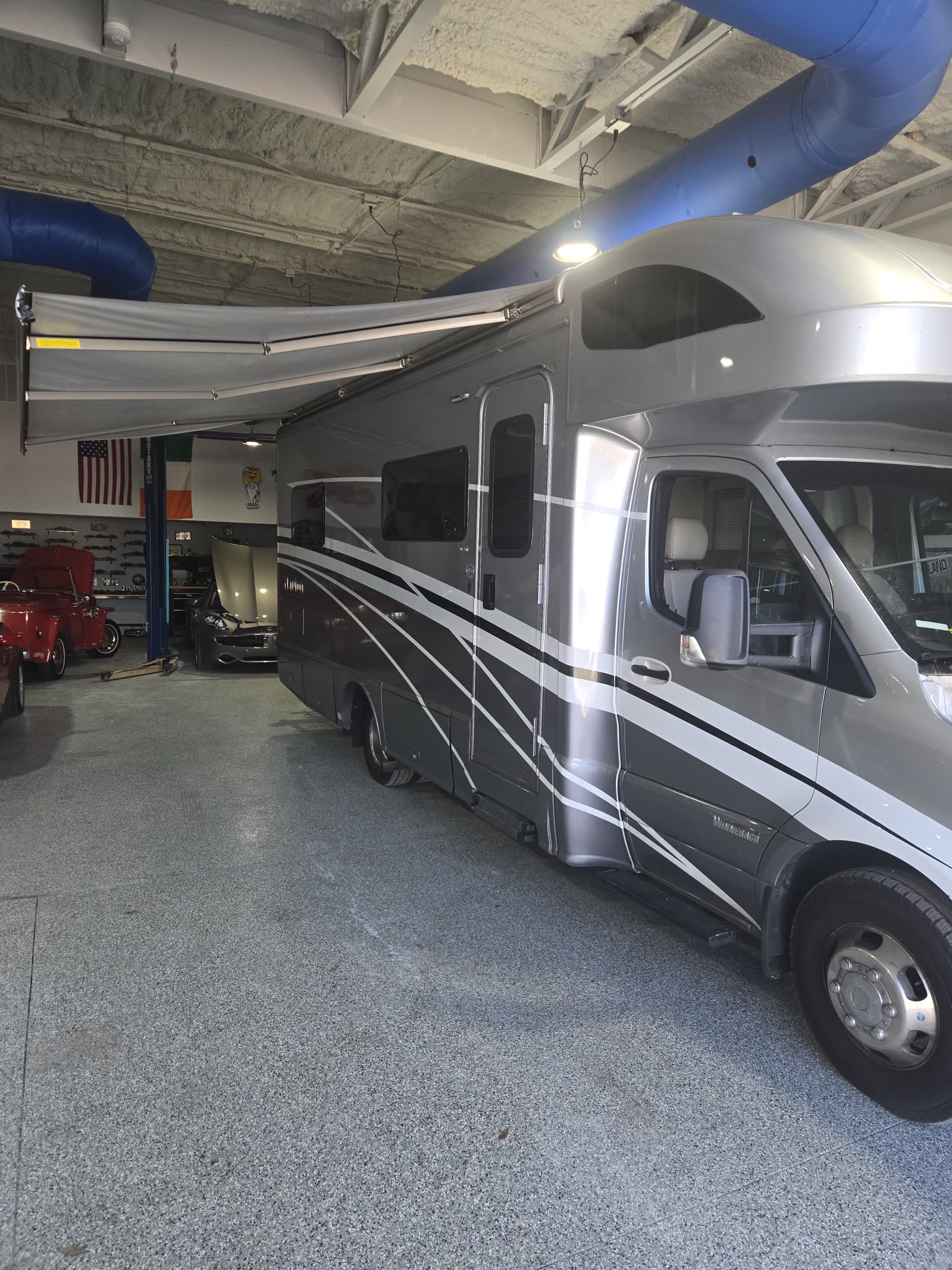 Motorhome raised in an RV service bay for inspection and repair